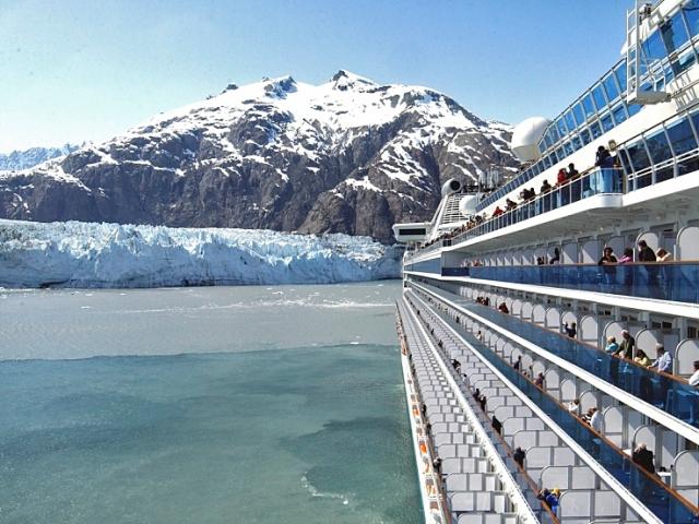 Cruise passengers taking photos of Glacier Bay from their cabin's balcony on a Princess Cruise.